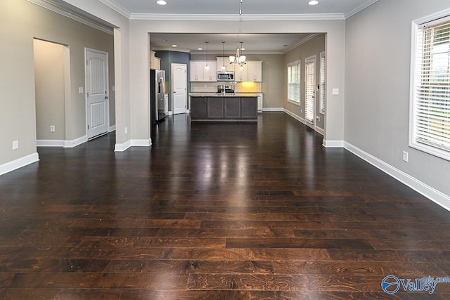 unfurnished living room featuring dark wood-type flooring and ornamental molding