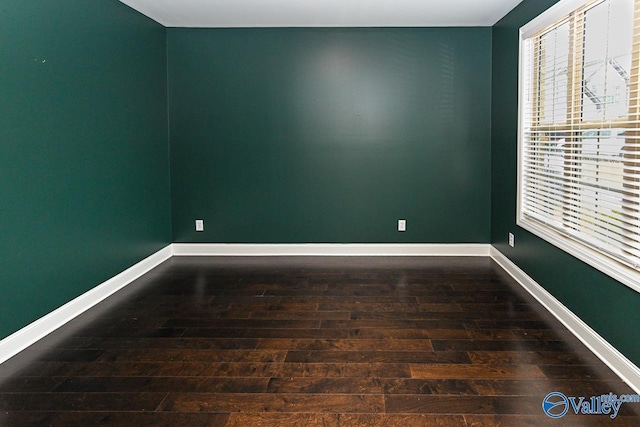 empty room featuring dark wood-type flooring