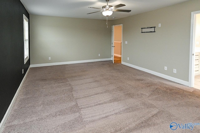 empty room featuring carpet flooring and ceiling fan