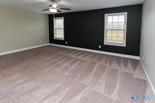 empty room featuring carpet flooring and ceiling fan