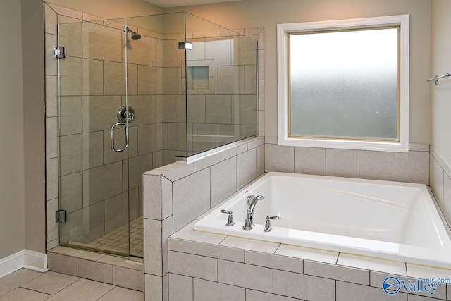 bathroom with tile patterned floors and shower with separate bathtub