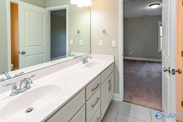 bathroom with tile patterned flooring, vanity, and toilet