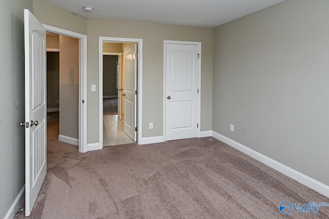 unfurnished bedroom with light colored carpet