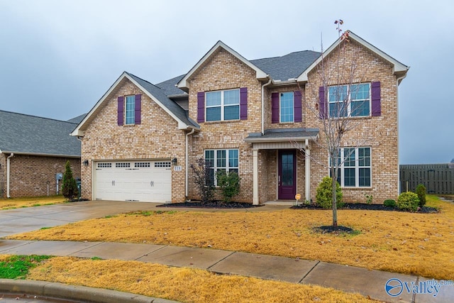 view of front of property with a front lawn and a garage