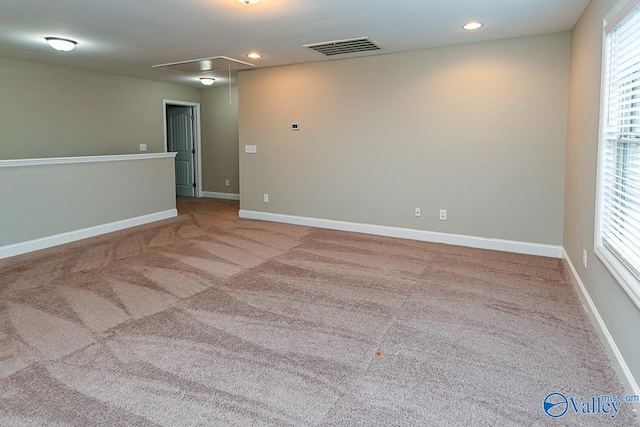 empty room featuring light colored carpet