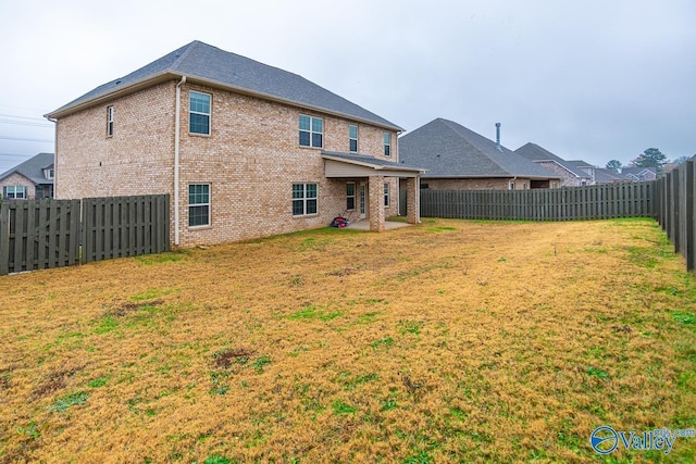 rear view of property with a patio area and a yard