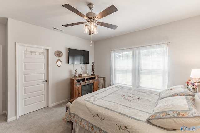 carpeted bedroom with baseboards, visible vents, and ceiling fan