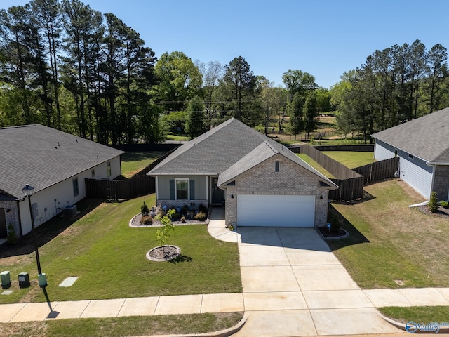 ranch-style home with a front lawn, driveway, fence, and a garage