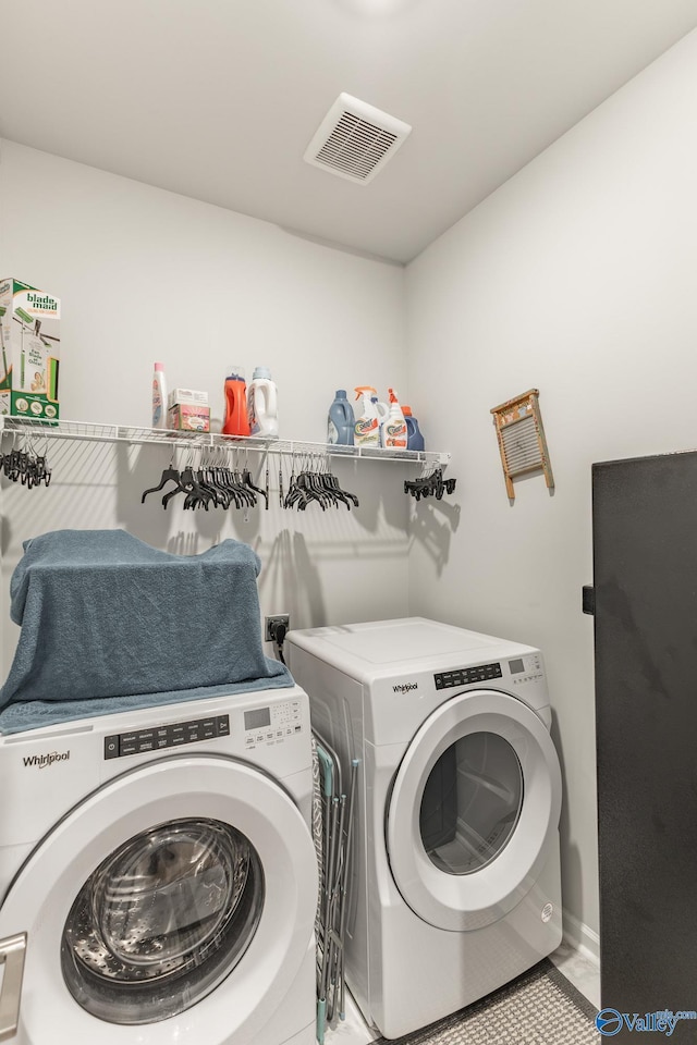 laundry area featuring washing machine and dryer, laundry area, and visible vents