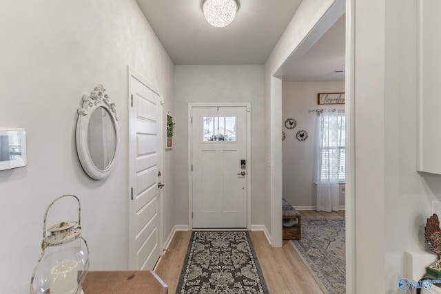 entryway featuring light wood-style floors and baseboards