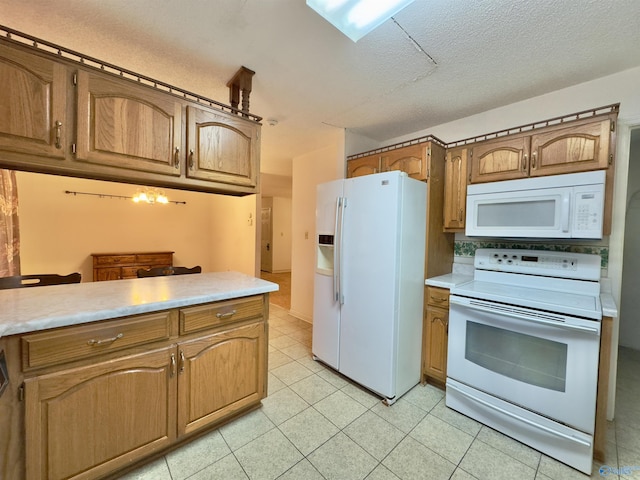 kitchen featuring a textured ceiling and white appliances