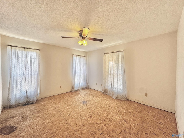 unfurnished room featuring ceiling fan and a textured ceiling