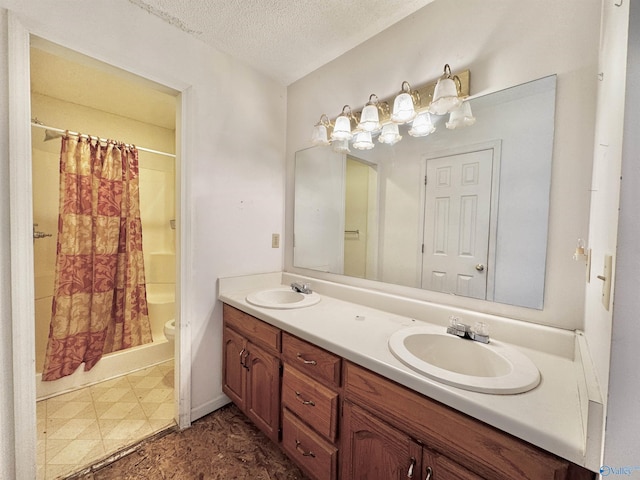 bathroom featuring vanity, a textured ceiling, toilet, and curtained shower