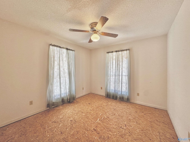 unfurnished room featuring a textured ceiling, plenty of natural light, and ceiling fan