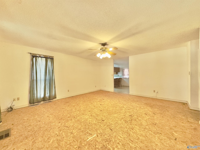 unfurnished room featuring a textured ceiling and ceiling fan