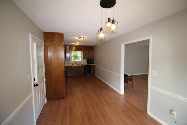 195 Holly Lynn Ln, Hazel Green, AL 35750 - kitchen with dark wood-style flooring, a sink, hanging light fixtures, dishwasher, and brown cabinetry