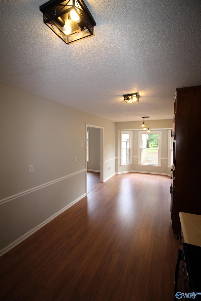 195 Holly Lynn Ln, Hazel Green, AL 35750 - spare room featuring dark wood-style flooring, a textured ceiling, and baseboards