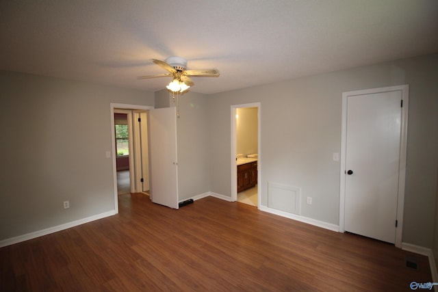 195 Holly Lynn Ln, Hazel Green, AL 35750 - unfurnished bedroom with dark wood-type flooring, baseboards, connected bathroom, and a ceiling fan