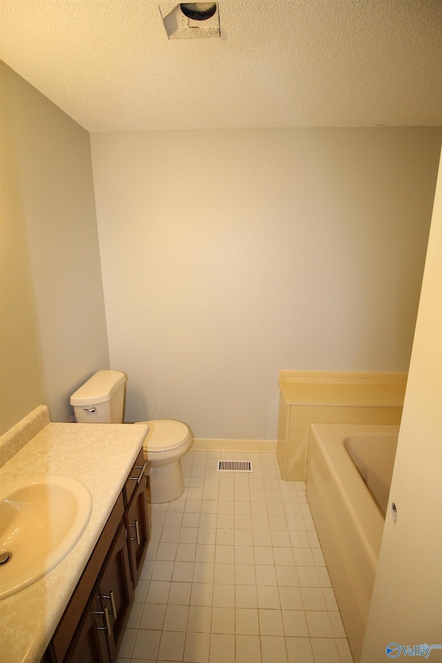 195 Holly Lynn Ln, Hazel Green, AL 35750 - bathroom with a garden tub, toilet, vanity, tile patterned flooring, and a textured ceiling