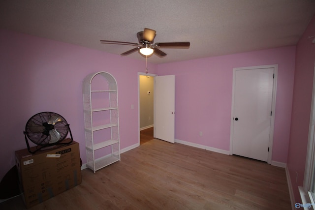 195 Holly Lynn Ln, Hazel Green, AL 35750 - unfurnished bedroom featuring wood finished floors, baseboards, and a ceiling fan