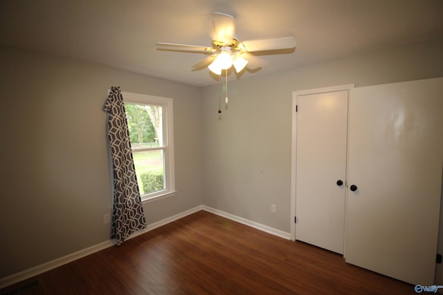 195 Holly Lynn Ln, Hazel Green, AL 35750 - unfurnished bedroom with dark wood-style floors, baseboards, and a ceiling fan