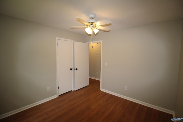 195 Holly Lynn Ln, Hazel Green, AL 35750 - unfurnished bedroom featuring dark wood-type flooring, baseboards, and ceiling fan