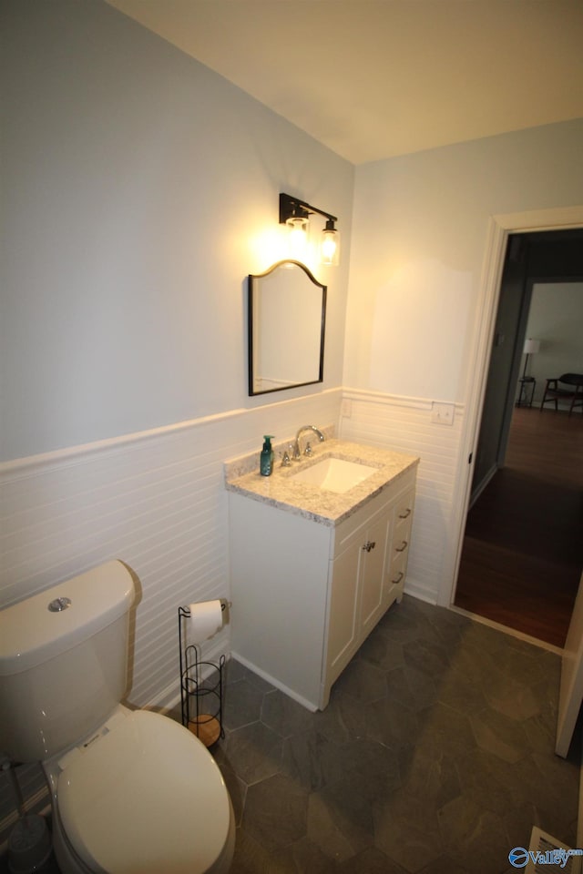 195 Holly Lynn Ln, Hazel Green, AL 35750 - half bathroom featuring a wainscoted wall, vanity, and toilet