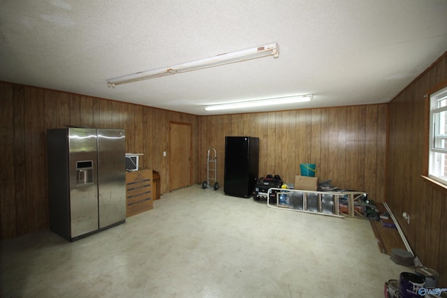 195 Holly Lynn Ln, Hazel Green, AL 35750 - interior space with stainless steel refrigerator with ice dispenser and wooden walls