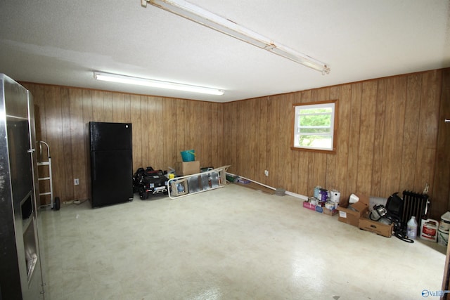 195 Holly Lynn Ln, Hazel Green, AL 35750 - basement featuring freestanding refrigerator, wood walls, and tile patterned floors