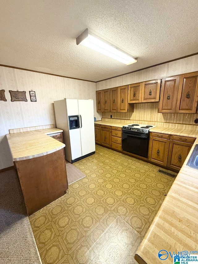 kitchen with a textured ceiling, black / electric stove, ornamental molding, wooden walls, and white refrigerator with ice dispenser