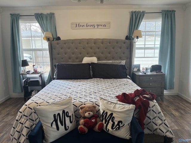 bedroom featuring ornamental molding and dark hardwood / wood-style flooring