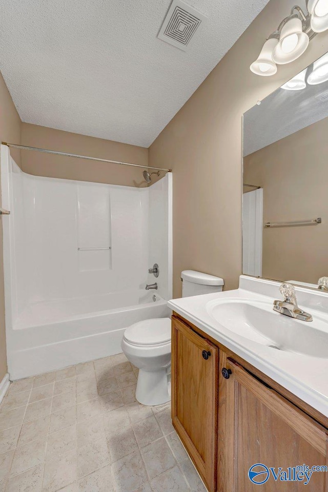 full bathroom with a textured ceiling, shower / bathtub combination, vanity, and toilet