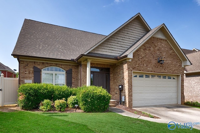 view of front of property with a front yard and a garage