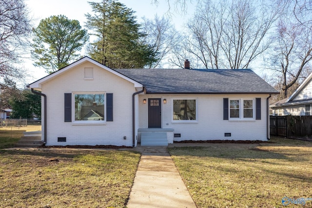 view of front of house with a front lawn, fence, roof with shingles, and crawl space