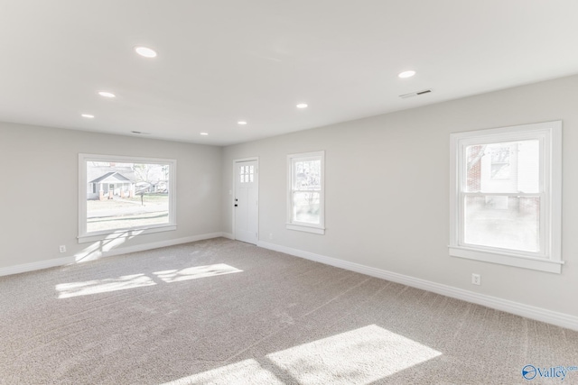 spare room featuring recessed lighting, visible vents, baseboards, and light colored carpet