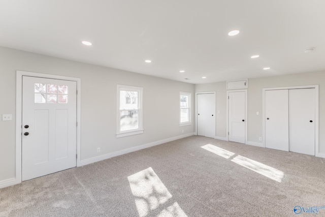 foyer entrance featuring recessed lighting, baseboards, and carpet