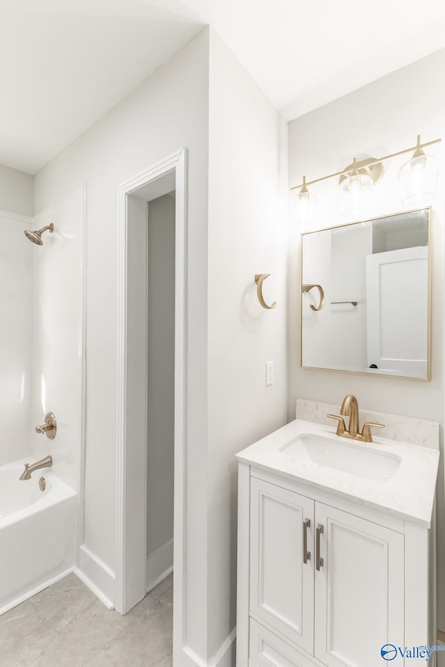 full bath featuring baseboards, vanity, and shower / bathtub combination