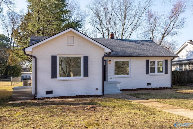 view of front of property featuring a front yard, fence, a chimney, and crawl space