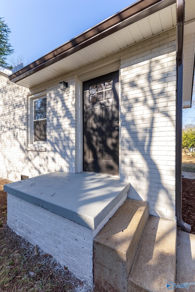 exterior space with brick siding