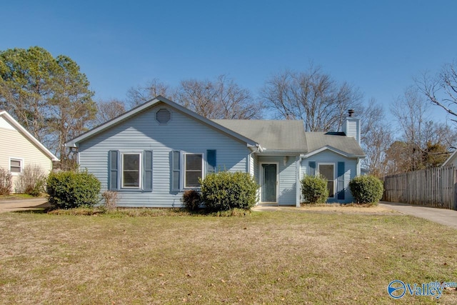 ranch-style house featuring a front lawn, a chimney, and fence