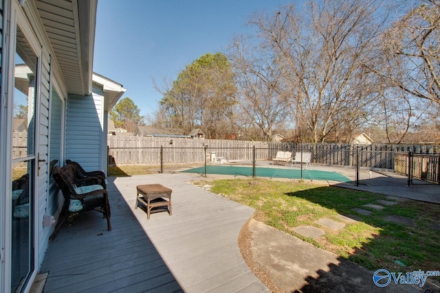 view of pool featuring a fenced backyard, a fenced in pool, and a wooden deck