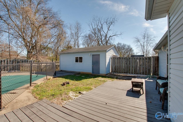 wooden terrace with a yard, a fenced backyard, a fenced in pool, and an outbuilding