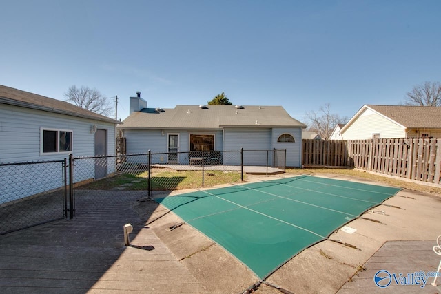 view of swimming pool featuring a fenced backyard, a gate, and a patio