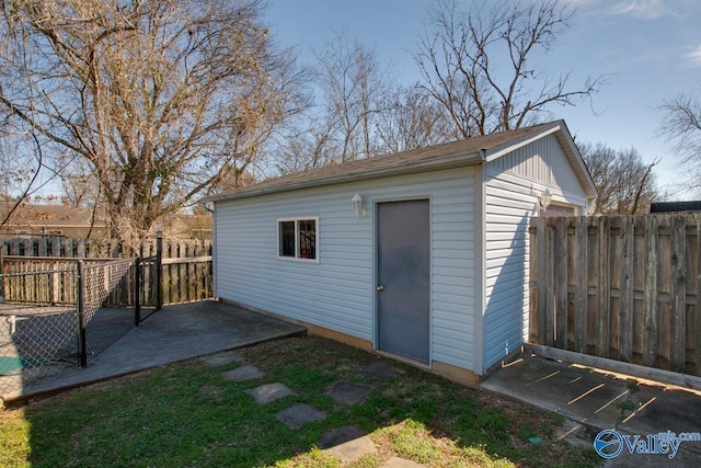 view of outbuilding with a fenced backyard and an outbuilding