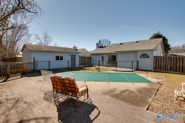 view of pool with a fenced backyard and a wooden deck