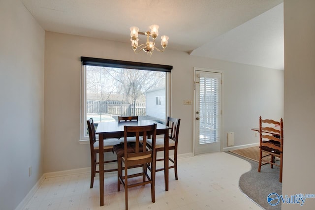 dining room with a chandelier, baseboards, and light floors