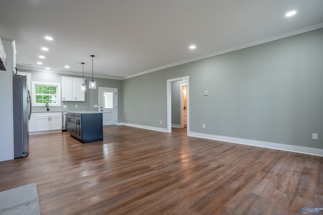 55 Edgewood St, Rainsville, AL 35986 - kitchen featuring appliances with stainless steel finishes, a kitchen island, open floor plan, crown molding, and white cabinets