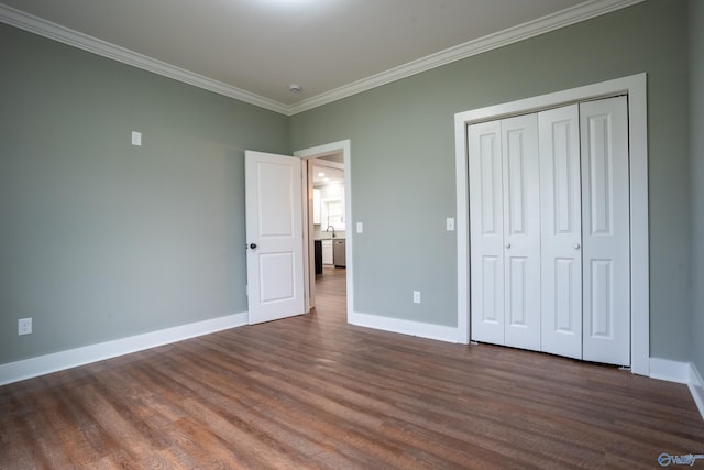 55 Edgewood St, Rainsville, AL 35986 - unfurnished bedroom with ornamental molding, dark wood-style floors, baseboards, and a closet