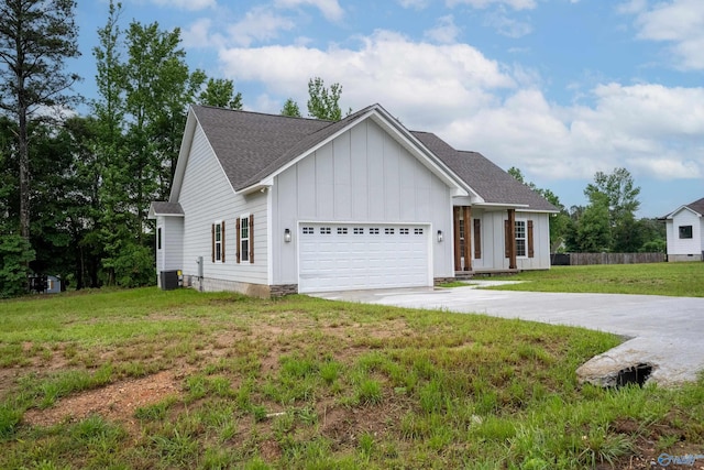 55 Edgewood St, Rainsville, AL 35986 - view of front of property with board and batten siding, central AC, concrete driveway, an attached garage, and roof with shingles