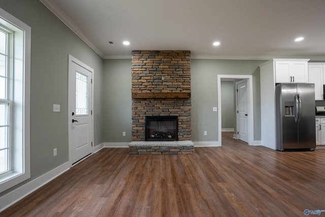 55 Edgewood St, Rainsville, AL 35986 - unfurnished living room with ornamental molding, dark wood finished floors, a stone fireplace, baseboards, and recessed lighting